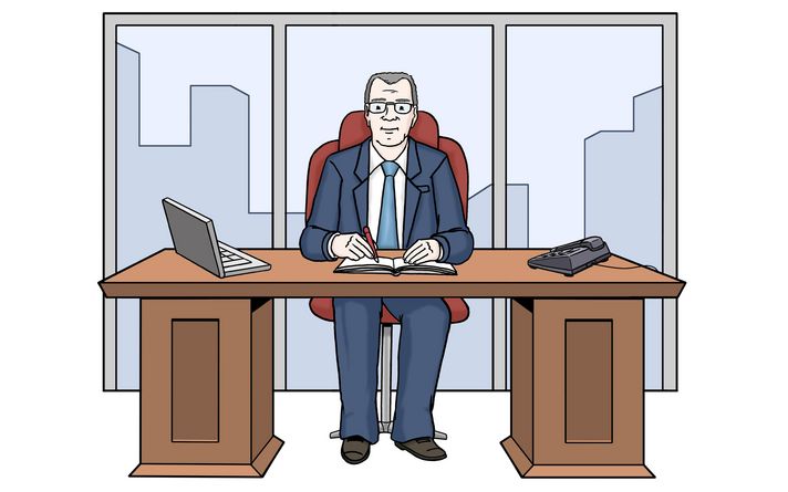 Ein Mann sitzt in seinem Büro an einem Schreibtisch